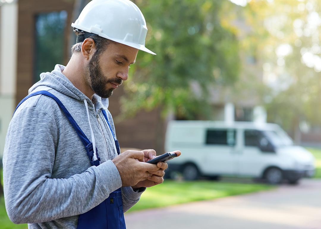 contractor checking his phone